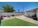 A fully fenced backyard featuring artificial turf, concrete, and a charming patio area, perfect for outdoor living at 1816 Silver Birch Ln, Las Vegas, NV 89104