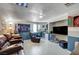 Relaxing basement with comfy seating, mounted TV, and sports-themed decor at 1816 Silver Birch Ln, Las Vegas, NV 89104