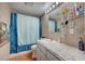 Bathroom featuring tiled walls, granite countertop, and a full shower and tub at 1816 Silver Birch Ln, Las Vegas, NV 89104