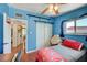 This bedroom features bright blue walls, wood floor, and closet space at 1816 Silver Birch Ln, Las Vegas, NV 89104