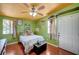 Cozy bedroom with a ceiling fan, hardwood floors and door to the outside at 1816 Silver Birch Ln, Las Vegas, NV 89104