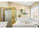 Bright bathroom featuring a large soaking tub and a separate gold-trimmed glass shower at 2021 Summit Pointe Dr, Las Vegas, NV 89117