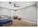 Charming bedroom showcasing a ceiling fan, natural light, and carpet flooring at 2021 Summit Pointe Dr, Las Vegas, NV 89117