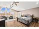 Spacious main bedroom with high ceilings, three ceiling fans, and a sitting area by arched windows at 2021 Summit Pointe Dr, Las Vegas, NV 89117