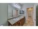 Bright bathroom with a granite countertop, dual sinks, and a large mirror at 2099 Port Royal Dr, Laughlin, NV 89029