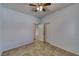 Neutral bedroom with tile floors, ceiling fan, and double door closets at 2099 Port Royal Dr, Laughlin, NV 89029