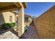 Side yard with brick paver pathway, block wall, and low-maintenance landscaping at 2099 Port Royal Dr, Laughlin, NV 89029