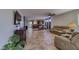 Spacious living room with tile flooring, neutral paint, and seamless flow to the kitchen and dining area at 2099 Port Royal Dr, Laughlin, NV 89029