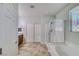 Main bathroom featuring a soaking tub, glass shower and tile flooring at 2099 Port Royal Dr, Laughlin, NV 89029