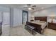 Comfortable main bedroom with dark wood furniture, ceiling fan and tile flooring at 2099 Port Royal Dr, Laughlin, NV 89029