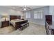 Primary bedroom featuring a ceiling fan, tile floors, and wood furniture at 2099 Port Royal Dr, Laughlin, NV 89029
