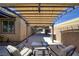 Spacious covered patio with metal overhang, neutral wall color, and comfortable seating at 2099 Port Royal Dr, Laughlin, NV 89029