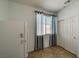 Side room with window, blind, refrigerator, tile floors and sliding door closet at 2099 Port Royal Dr, Laughlin, NV 89029