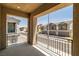 Balcony with black metal railings overlooking a quiet street with townhome buildings at 216 Callen Falls Ave # 1423, Henderson, NV 89011
