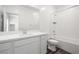 Bright bathroom with double vanity, white cabinetry, and a shower-tub combo at 216 Callen Falls Ave # 1423, Henderson, NV 89011