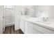 Bathroom featuring double sinks, white cabinets, and a separate tiled shower at 216 Callen Falls Ave # 1423, Henderson, NV 89011