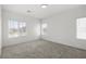 Well lit bedroom with neutral carpet, three windows, and fresh, white walls at 216 Callen Falls Ave # 1423, Henderson, NV 89011