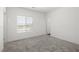 Bedroom featuring neutral carpeting, a window with blinds, and a white door at 216 Callen Falls Ave # 1423, Henderson, NV 89011