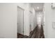 Hallway with wood-look flooring leading to carpeted bedrooms and other rooms at 216 Callen Falls Ave # 1423, Henderson, NV 89011