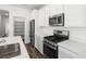 Close up of the modern kitchen with stainless appliances and quartz countertops at 216 Callen Falls Ave # 1423, Henderson, NV 89011