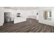Open-concept living space with modern kitchen, stainless appliances, and wood-look flooring at 216 Callen Falls Ave # 1423, Henderson, NV 89011