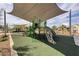 A large jungle gym playground under a shade sail, offering great recreation for families at 216 Callen Falls Ave # 1423, Henderson, NV 89011