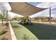 Community playground featuring shaded play structures, benches, and landscaped surroundings at 216 Callen Falls Ave # 1423, Henderson, NV 89011