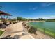 Scenic walking path along the community pond with lush landscaping and seating areas at 216 Callen Falls Ave # 1423, Henderson, NV 89011
