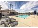 Community pool with lounge area, umbrellas and picnic tables, perfect for relaxing at 216 Callen Falls Ave # 1423, Henderson, NV 89011