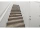 Carpeted stairs lead to the upper level of this modern home at 216 Callen Falls Ave # 1423, Henderson, NV 89011