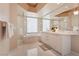 Bright bathroom features a large mirror, double vanity, walk-in shower, and tub at 222 Karen Ave # 3208, Las Vegas, NV 89109