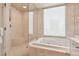 Bright bathroom featuring a large window, soaking tub, and walk-in shower at 222 Karen Ave # 3208, Las Vegas, NV 89109