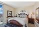 Comfortable bedroom with decorative headboard and decor, offering scenic city views from a large window at 222 Karen Ave # 3208, Las Vegas, NV 89109