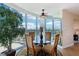 Bright dining area with city views through curved windows and a glass-topped table with seating for four at 222 Karen Ave # 3208, Las Vegas, NV 89109