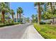 Well-maintained driveway leads to a secure gatehouse entrance, framed by palm trees and manicured landscaping at 222 Karen Ave # 3208, Las Vegas, NV 89109