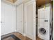 Compact laundry room with stacked washer and dryer, with a door leading outside at 222 Karen Ave # 3208, Las Vegas, NV 89109