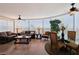 Spacious living room featuring a curved wall of windows offering city views, tile floors, and ceiling fans at 222 Karen Ave # 3208, Las Vegas, NV 89109