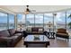 Modern living room featuring a curved wall of windows offering city views and comfortable leather furniture at 222 Karen Ave # 3208, Las Vegas, NV 89109