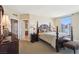 Elegant main bedroom with a large bed, soft lighting, and ensuite bathroom at 222 Karen Ave # 3208, Las Vegas, NV 89109
