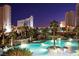 Stunning outdoor pool with waterfalls and lush landscaping offering a resort-style oasis at night at 222 Karen Ave # 3208, Las Vegas, NV 89109