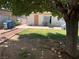 The backyard features a grassy area, concrete patio, and shade from a large tree, perfect for outdoor enjoyment at 225 Dogwood St, Henderson, NV 89015