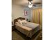 Bedroom features a ceiling fan, side tables with lamps and light brown patterned bedspread at 225 Dogwood St, Henderson, NV 89015