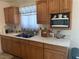 Traditional kitchen featuring wood cabinetry, ample counter space, and a microwave at 225 Dogwood St, Henderson, NV 89015