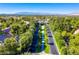 Aerial view of the community showcasing tree-lined streets and a scenic landscape with mountain views in the distance at 2346 Villandry Ct, Henderson, NV 89074