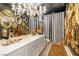 Ornate bathroom featuring multiple mirrors, chandeliers, and vanity space at 2346 Villandry Ct, Henderson, NV 89074