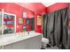 Bathroom with bright red walls, a vanity with sink, and dramatic artwork on the walls at 2346 Villandry Ct, Henderson, NV 89074