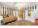Primary bedroom featuring bold striped walls, a luxurious bed, and plenty of storage at 2346 Villandry Ct, Henderson, NV 89074