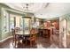 Dining area adjoining kitchen offers a large table, bay window views, and stylish overhead lighting at 2346 Villandry Ct, Henderson, NV 89074