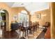 Elegant dining room boasts a grand chandelier, a large table for ten, and access to the outdoors at 2346 Villandry Ct, Henderson, NV 89074