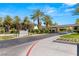 Elegant gated community entrance featuring lush landscaping, water features, and a secure entry point for residents at 2346 Villandry Ct, Henderson, NV 89074